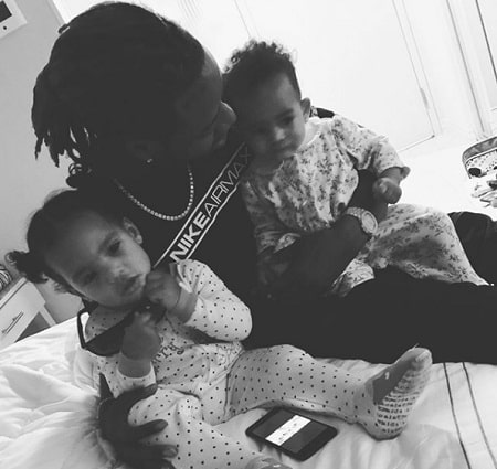 A picture of Fetty Wap with two of seven kids.